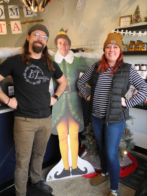 Better Together Café owners Zach Kinzer (left) and Becky Kinzer have transformed their business with an "Elf"-themed pop-up for December. Becky Kinzer said the goal was to make the café "look like Gimbels" from the movie.