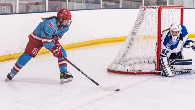 Arrowhead's Alexa Jarvis (8) looks for a shot against Lakeshore Lightning goalie Elizabeth Bowers (42) during the game at the Ozaukee Ice Center in Mequon on Wednesday, Nov. 29, 2023.