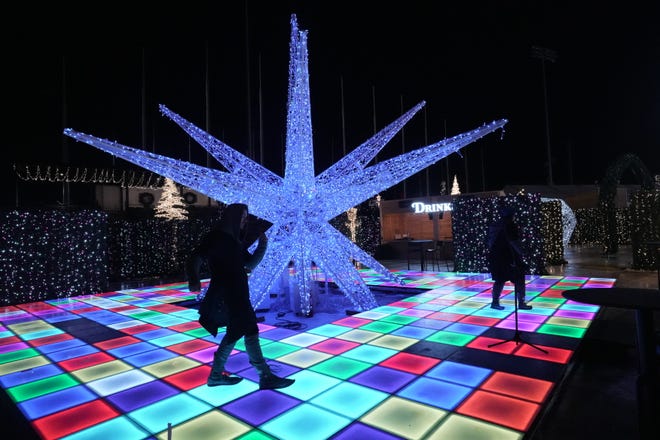 An LED dance floor is one of the activities inside the Enchant Christmas at Ballpark Commons in Franklin.