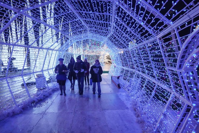 Visitors will make their way through tunnels made of Christmas lights at the Enchant Christmas light maze in Franklin.