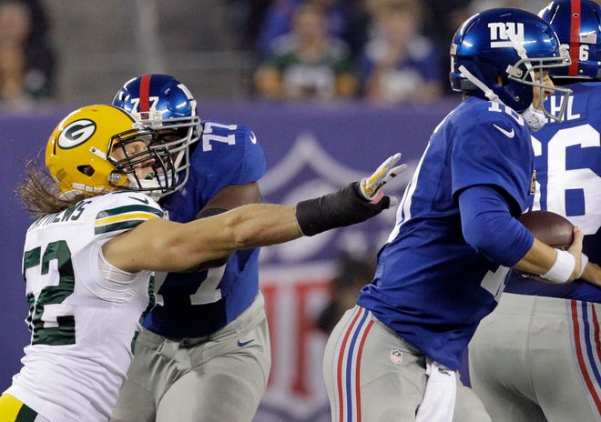 New York Giants quarterback Eli Manning (10) eludes the grasp of Green Bay Packers linebacker Clay Matthews (52) during the first quarter of their game on November 17, 2013 at MetLife Stadium in East Rutherford, N.J.