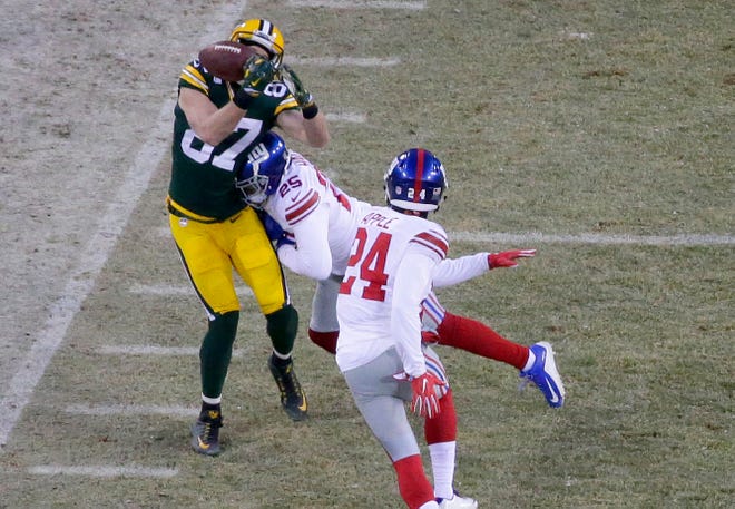 Wide receiver Jordy Nelson takes a hard hit to his left side from New York Giants safety Leon Hall during the Packers wild-card victory on January 8, 2017, at Lambeau Field. The Packers won 38-13.