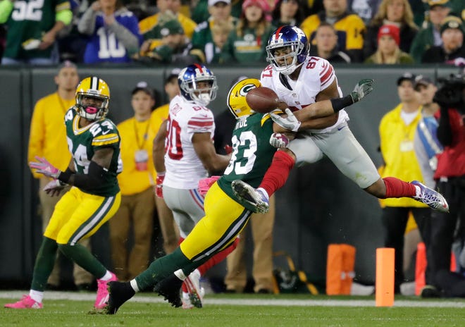 Green Bay Packers' Micah Hyde breaks up a pass intended for New York Giants' Sterling Shepard on October 9, 2016, at Lambeau Field in Green Bay, Wis.