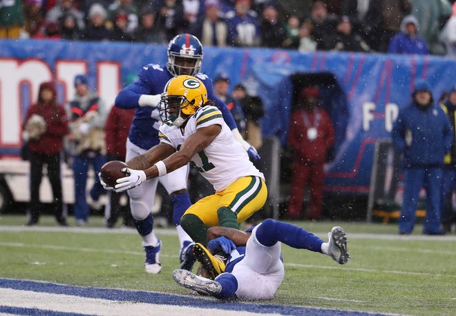 Davante Adams (17) of the Green Bay Packers scores a touchdown against Antoine Bethea (41) of the New York Giants during their game at MetLife Stadium on December 01, 2019 in East Rutherford, New Jersey.