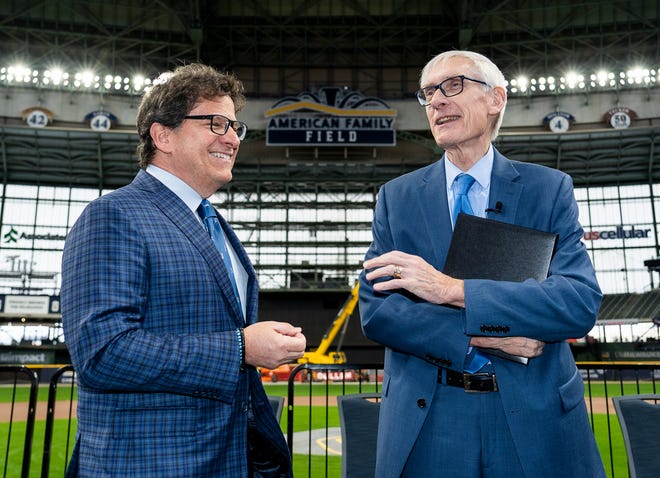 Gov. Tony Evers talks with Milwaukee Brewers owner (Left) Mark Attanasio after signing Assembly Bill 438 and Assembly Bill 439, a bipartisan package of bills passed by the Wisconsin State Legislature to keep the Milwaukee Brewers and Major League Baseball (MLB) in Wisconsin through 2050, on Tuesday December 5, 2023 at American Family Field in Milwaukee, Wis.