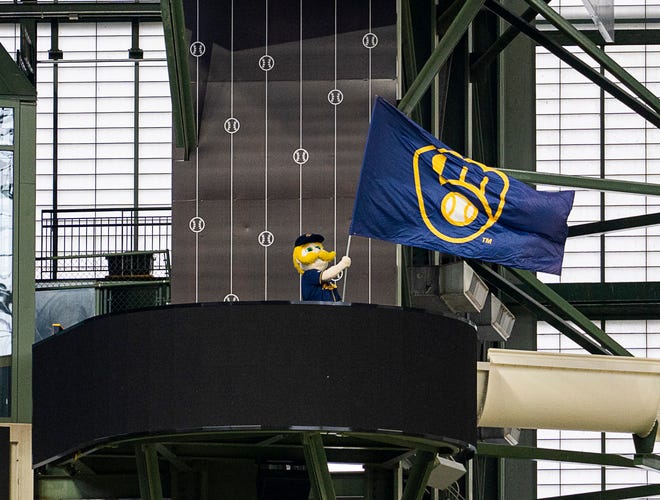 Bernie Brewer waves the Brewers flag as Gov. Tony Evers signs Assembly Bill 438 and Assembly Bill 439, a bipartisan package of bills passed by the Wisconsin State Legislature to keep the Milwaukee Brewers and Major League Baseball (MLB) in Wisconsin through 2050, on Tuesday December 5, 2023 at American Family Field in Milwaukee, Wis.