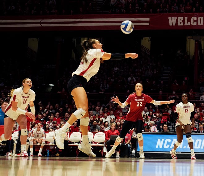 Wisconsin setter Izzy Ashburn (11) runs to hit the return during the first set of the NCAA Regional Volleyball semifinal match against Penn State on Thursday December 7, 2023 at the UW Field House in Madison, Wis.