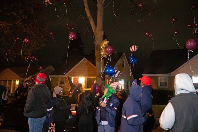 Community members release balloons into the sky during a vigil on Dec. 9, 2023 honoring the life of Aundre Cross, a 44-year-old U.S. Postal Service worker who was shot and killed while delivering mail a year ago on Dec. 9, 2022 in the 5000 block of North 65th Street in Milwaukee.