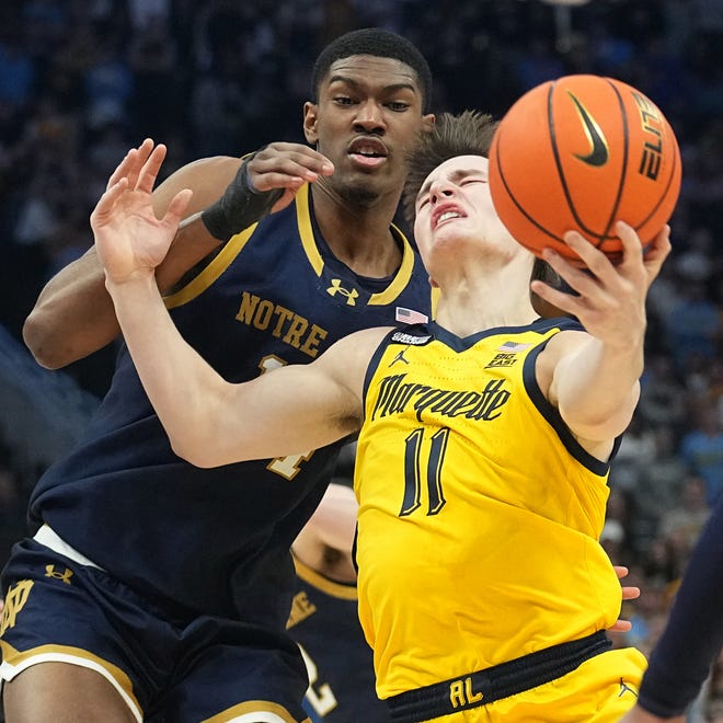 Marquette guard Tyler Kolek (11) is fouled by Notre Dame forward Kebba Njie (14) during the first half of their game Saturday, December 9, 2023 at Fiserv Forum in Milwaukee, Wisconsin.