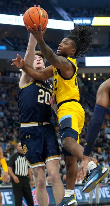 Marquette guard Sean Jones (22) scores on Notre Dame guard J.R. Konieczny (20) during the first half of their game Saturday, December 9, 2023 at Fiserv Forum in Milwaukee, Wisconsin.