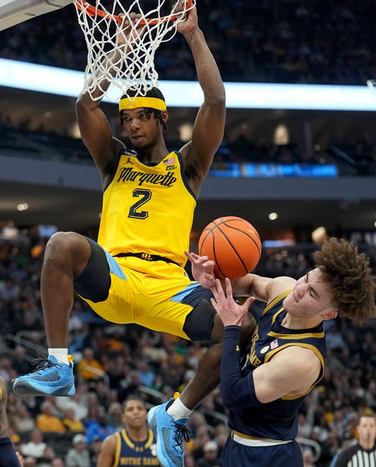 Marquette guard Chase Ross (2) dunks the ball on Notre Dame guard Braeden Shrewsberry (11) during the first half of their game Saturday, December 9, 2023 at Fiserv Forum in Milwaukee, Wisconsin.