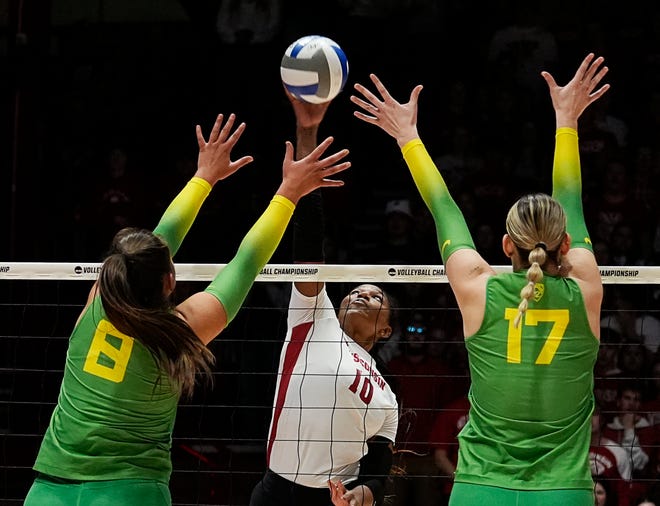 Oregon outside hitter Gabby Gonzales (8) and middle blocker Kara McGhee (17) attempt to block the shot from Wisconsin opposite Devyn Robinson (10) during the second set of the NCAA Regional Volleyball Finals match on Saturday December 9, 2023 at the UW Field House in Madison, Wis.