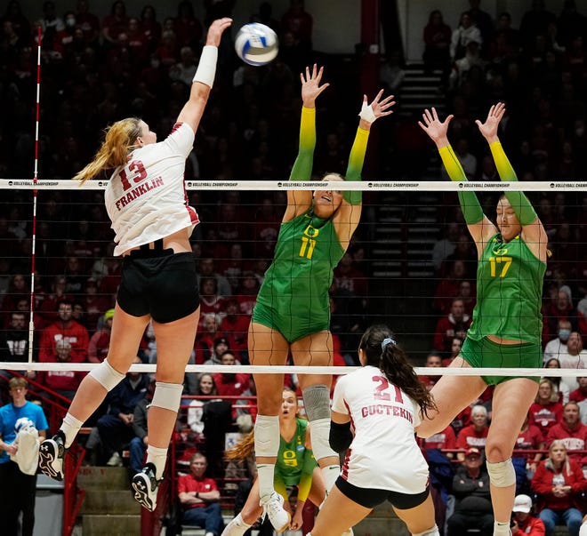 Oregon opposite Morgan Lewis (11) and middle blocker Kara McGhee (17) attempt to block the spike from Wisconsin outside hitter Sarah Franklin (13) during the second set of the NCAA Regional Volleyball Finals match on Saturday December 9, 2023 at the UW Field House in Madison, Wis.