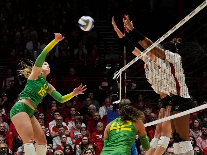 Wisconsin opposite Anna Smrek (14) and middle blocker Carter Booth (52) attempt to block the hit from Oregon outside hitter Mimi Colyer (15) during the second set of the NCAA Regional Volleyball Finals match on Saturday December 9, 2023 at the UW Field House in Madison, Wis.