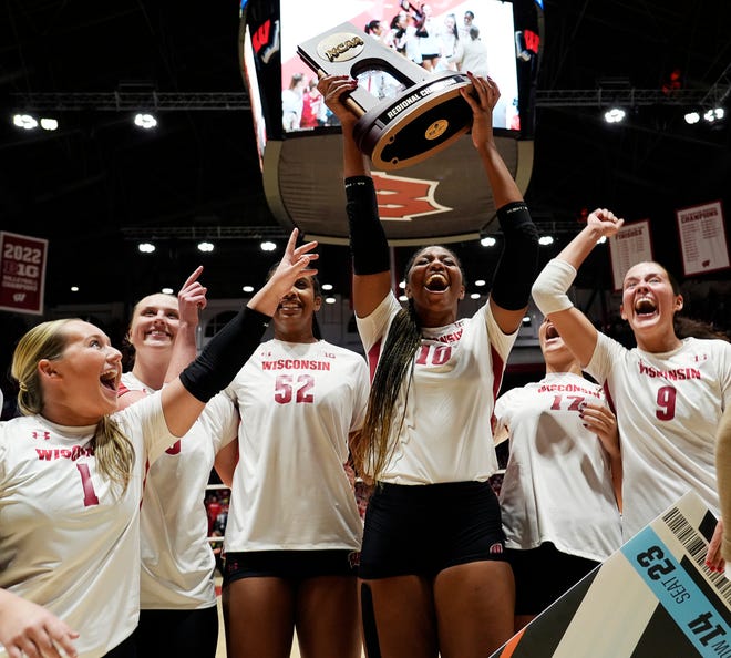 Wisconsin opposite Devyn Robinson (10) holds the NCAA Regional Volleyball Championship trophy as the team celebrates their victory over Oregon on Saturday December 9, 2023 at the UW Field House in Madison, Wis.